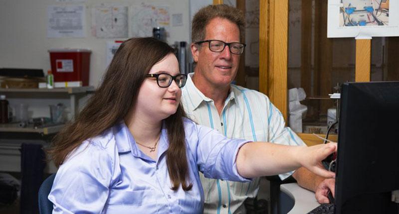 Distinguished Professor of Neurobiology Dr. Paul Garris, left, and graduate assistant Rebecca Chicosky analyze data collected in Garris' lab.